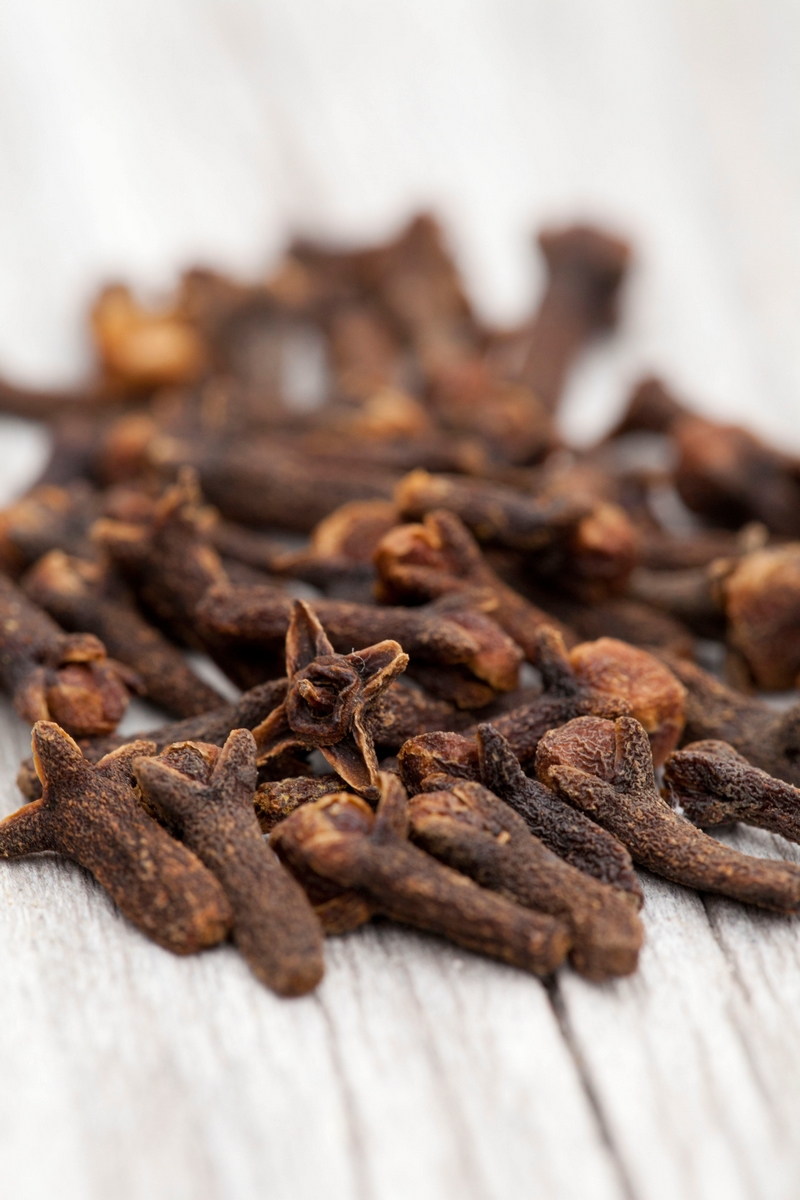 Shallow focus shot of clove spice on a white wooden surface
